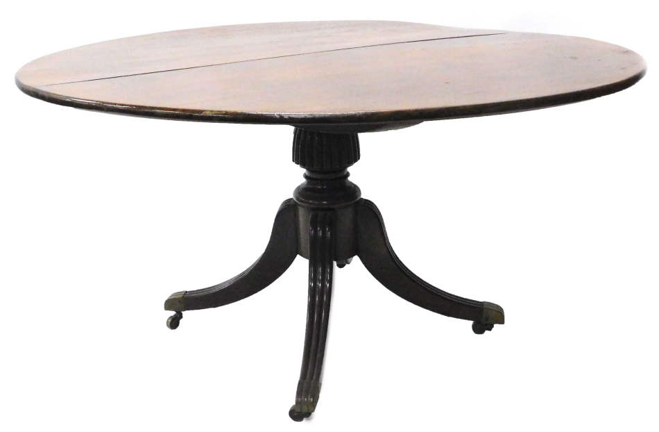 A George III mahogany dining table, the circular tilt top on a part fluted column and readed splayed