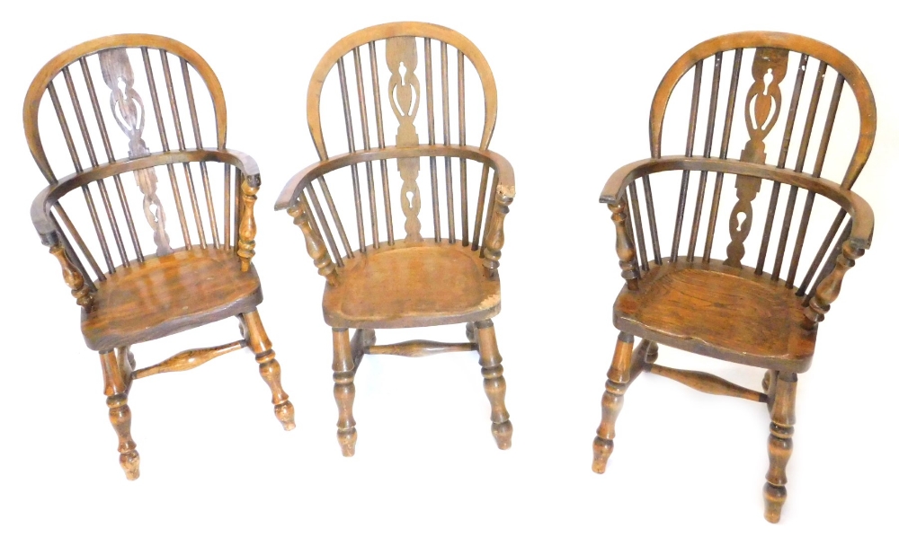 A pair of child's Windsor chairs, each with a pierced splat, and a solid seat on turned legs, and