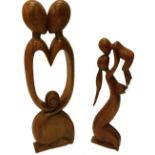 Two hardwood carvings one modelled in the form of two intertwined figures, with central pierced