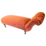 A Victorian ash day bed, upholstered in red fabric, on turned legs with ceramic castors.