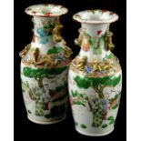 A pair of 19thC Chinese Canton porcelain vases, each decorated in famille verte palette with figures