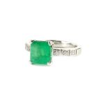 A platinum emerald and diamond ring, with central square cut emerald, in claw setting, approx 1.