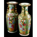 A pair of late 19thC Chinese Canton porcelain vases, each decorated in typical colours, 25cm H.