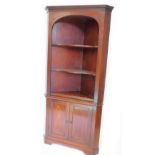 A 19thC mahogany corner cabinet, the top with a dental cornice above two open and shaped shelves,