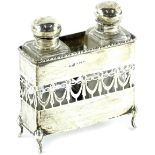 An early 20thC pierced silver scent bottle holder, containing two rectangular glass scent bottles