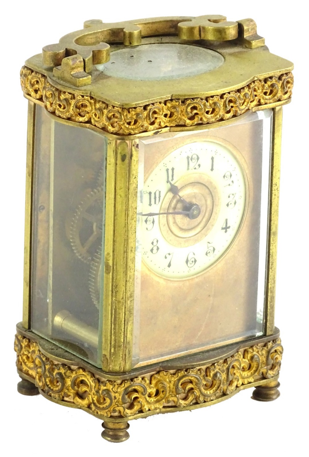 A late 19thC French carriage timepiece, the gilt brass case decorated with scrolls etc., the