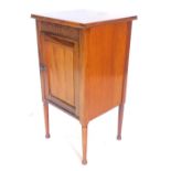 An Edwardian mahogany bedside cabinet, with a single panelled door, on octagonal turned legs, 40cm