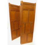 An oak three fold screen, each with panelled and carved sections, 201cm H, 201cm W.