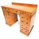 A Victorian mahogany dressing table, with a raised back, above an arrangement of eleven drawers, the