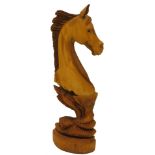 A carved hardwood horses head and neck, on an integral shaped base, 105cm H.