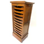 An early to mid 20thC oak filing cabinet, the rectangular top with a rising reading slope, above a