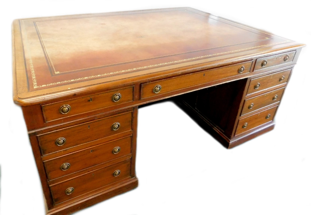 A late 19th/early 20thC mahogany partners desk in George III style, the rectangular top with a brown