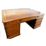 A late 19th/early 20thC mahogany partners desk in George III style, the rectangular top with a brown