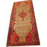 A Persian Hamadan rug, with a central medallion, on a beige ground with multiple borders, 270cm x