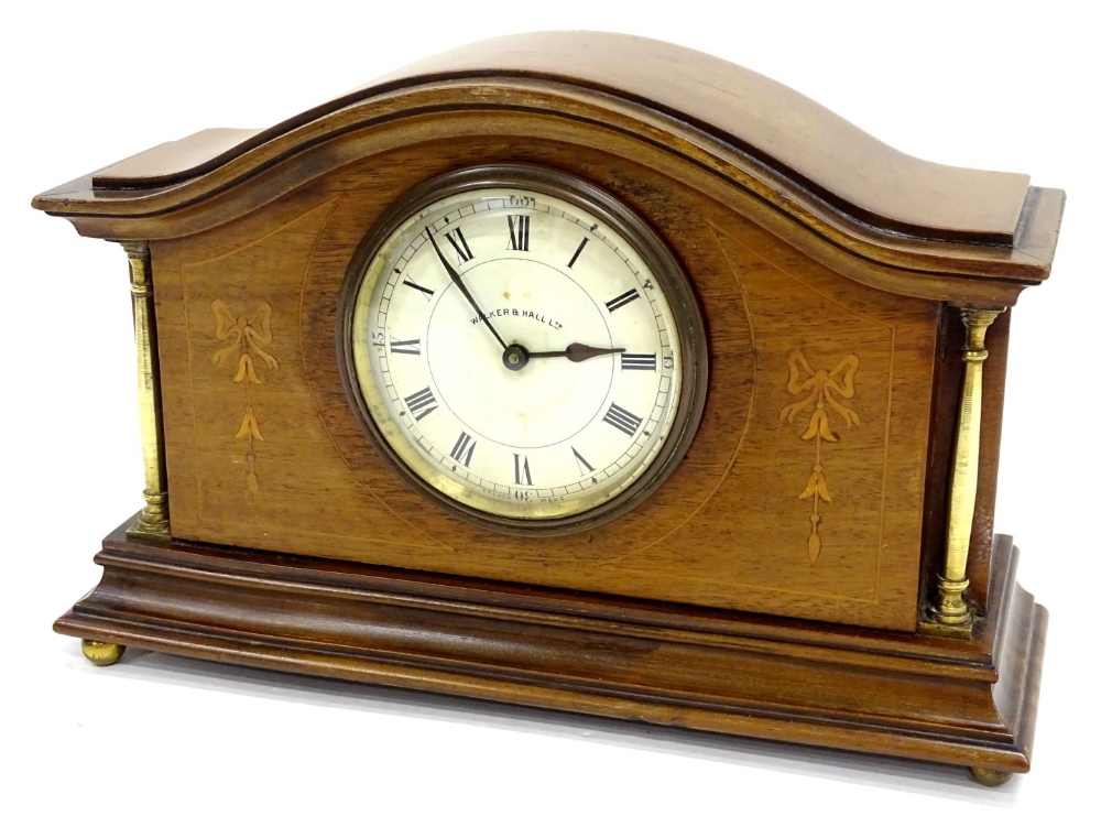 An Edwardian Walker and Hall mahogany and marquetry mantel timepiece, the circular dial with Roman