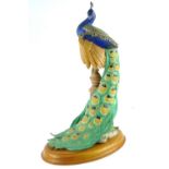 A Franklin Mint bisque porcelain figurine, The Royal Peacock, made for the Royal Society for the