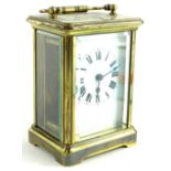 An early 20thC French brass carriage timepiece, with white enamel dial, 13cm H.