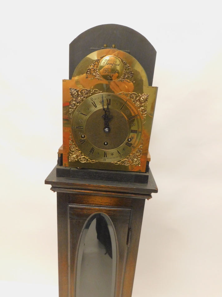A grandmother clock in oak case, the arched brass dial signed Tempus Fugit above a single door - Image 2 of 3
