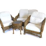 A conservatory three piece rattan suite, comprising two seater sofa, two armchairs, and a matching