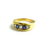 An 18ct gold sapphire and diamond dress ring, with two oval sapphires, and three diamonds, gypsy