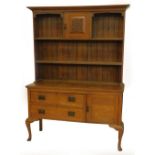 An early 20thC oak dresser, the raised back with two shelves for plates, the base with two drawers