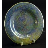 A Ruskin Pottery mottled blue lustre glazed plate, 17.5cm dia.