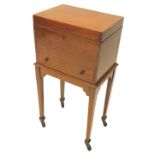 An Edwardian mahogany and boxwood strung work table, the hinged lid enclosing a fitted interior