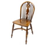 A Windsor chair, with a pierced splat, solid seat, on turned legs, with crinoline stretcher.