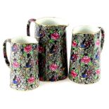 A graduated set of three late 19th/early 20thC transfer printed and hand painted jugs, each