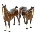 Two Beswick brown horses, each with white socks, one with cropped tail.