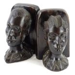 A pair of African ebony bookends, each carved with a male and female bust, 17cm H.