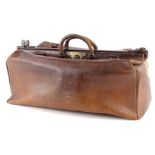 An early 20thC brown leather Gladstone bag stamped A Davis and Co, makers Strand London, bearing
