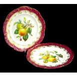 A pair of 19thC porcelain dessert plates, each decorated with apples and pears, within a puce and