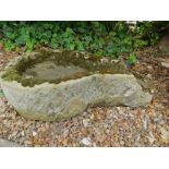 A carved stone bird bath, with spout to one end, 78cm L.