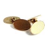 A pair of 9ct gold oval cufflinks, each with engine turned design and thin border, 11.8g.