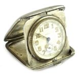 A Continental white metal Art Deco travelling clock, the case engraved with niello type decoration
