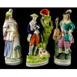 Three 19thC Staffordshire figures, to include a spill vase figurine of a Scotsman with a lamb,