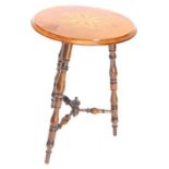 A late/early 20thC walnut gypsy type table, the circular top inlaid with a specimen timber star,