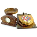 A collection of wooden items, to include an inlaid mantel clock, two University shields, a desk