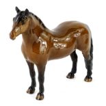 A light coloured brown Beswick pony, with long attached tail.