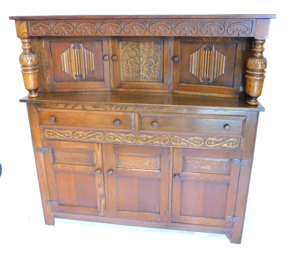 An oak dining room suite, comprising extending dining room table with two draw leaves on carved - Image 3 of 3