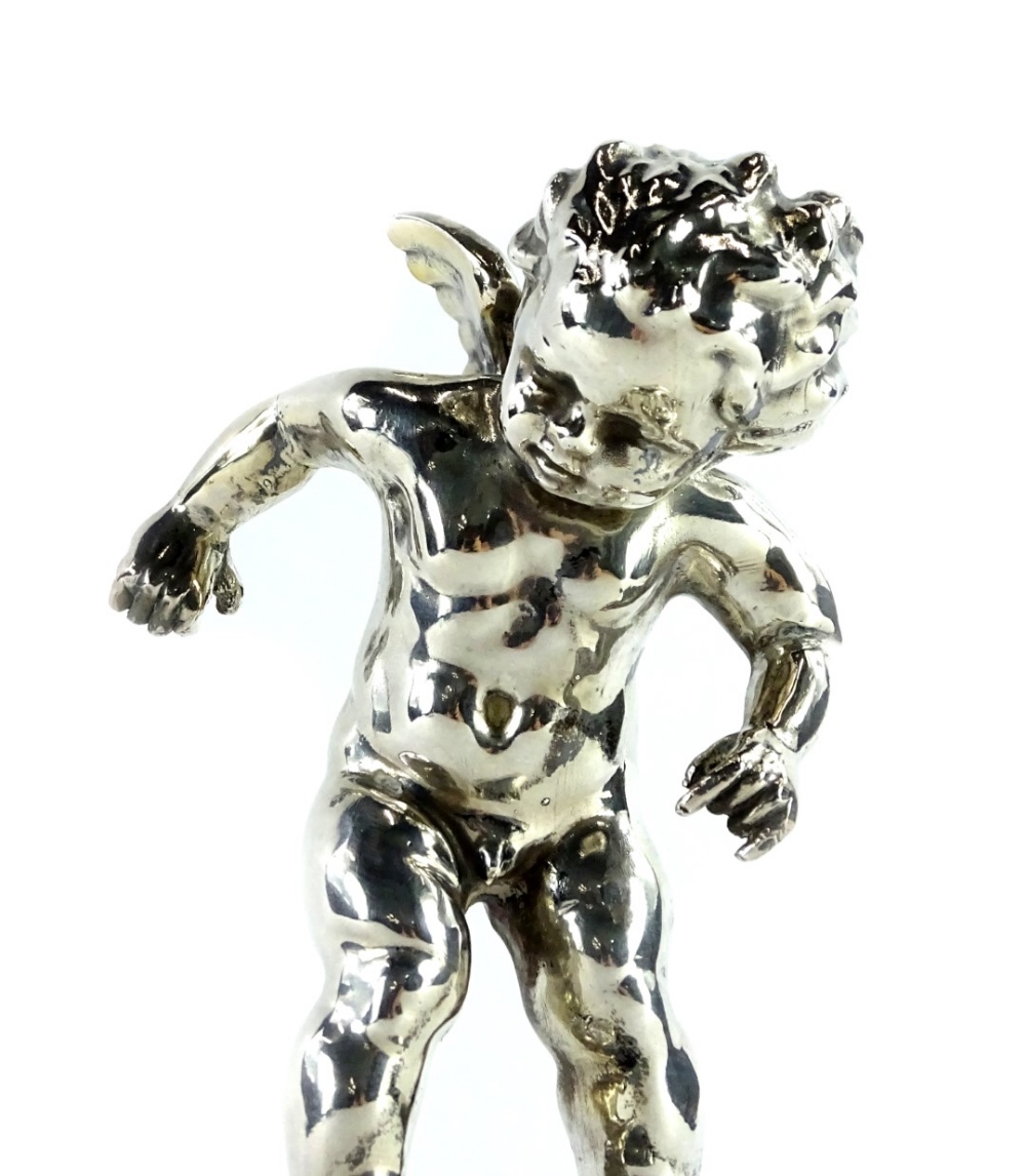 A silver coloured metal mantel clock, cast in the form of a putto on a globe, the movement stamped - Image 2 of 3