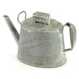 An unusual galvanised watering can, the hinged lid applied with a model of an engine, inscribed to