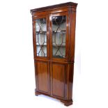 A 19thC mahogany standing corner cabinet, the top with a dental cornice above two glazed doors,
