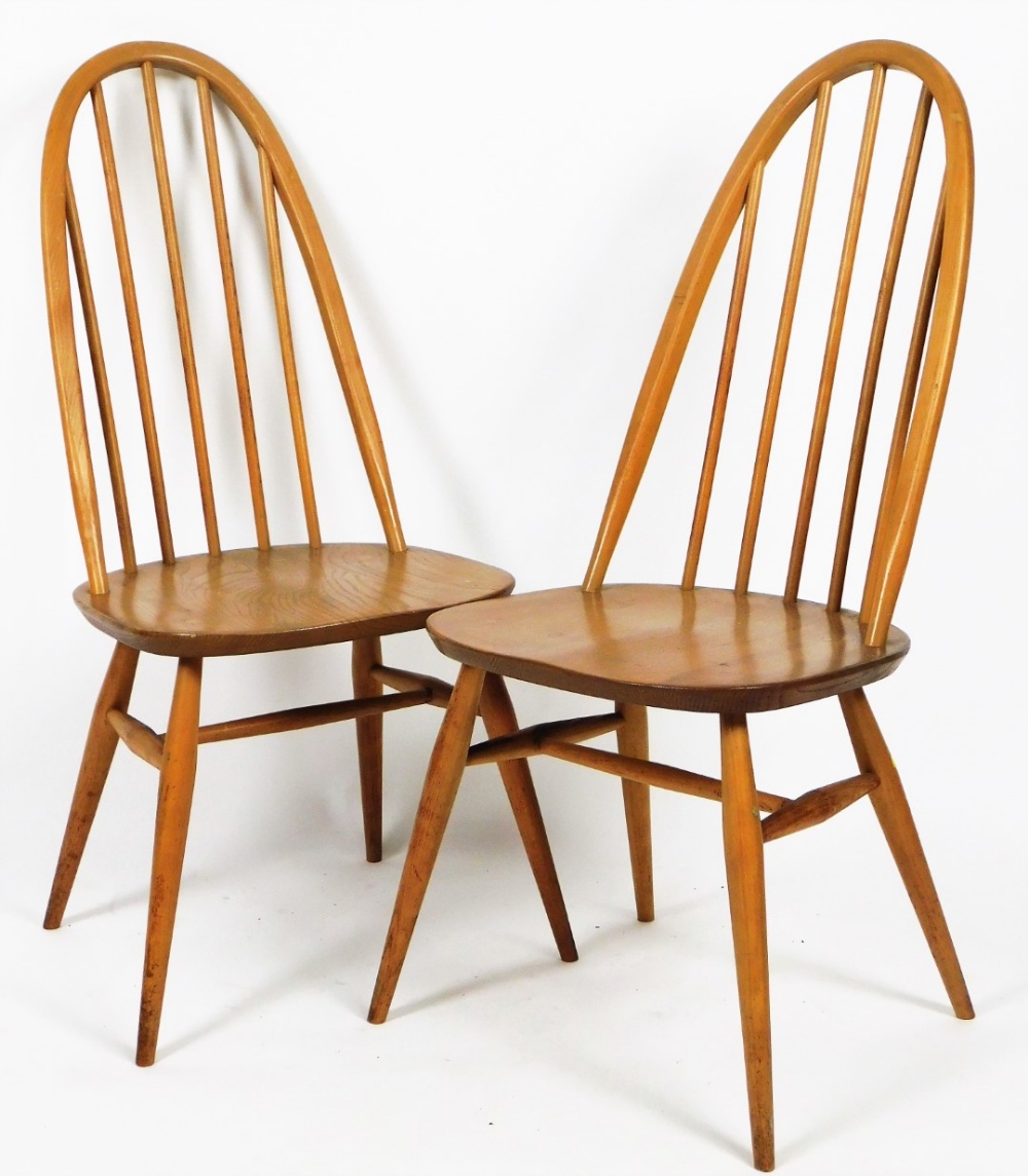 Two Ercol stick back chairs, with shaped seats, on turned legs joined by a H stretcher, unmarked,