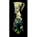 A Moorcroft pottery ewer, with tube line decoration of lilies, lily pads etc., impress marks to