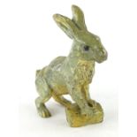 A late cold painted bronze figure of a rabbit or hare, standing on a tree stump in the manner of