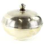 An Art Deco Bakelite and silver mounted powder compact or jar and cover, the circular lid with a