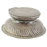 A late Victorian silver inkwell, the hinged lid engraved with a monogram, the base with gadrooned