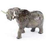 A Beswick pottery model of an elephant, with trunk raised etc, 38cm L.